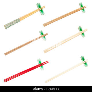 collection from various wooden chopsticks served on chopstick rest isolated on white background Stock Photo