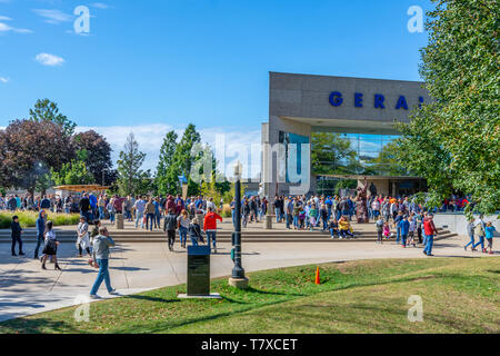 Crowd of people walking, enjoying a sunny day in front of the Gerald R. Ford Presidential Library and Museum in Grand Rapids, Michigan. Stock Photo