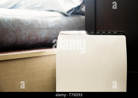 Air purifier in the bed room cleaner removing fine dust in house. Stock Photo