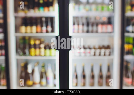 Background Blurred Defocused Beers are cooling in fridge, freezer or refrigerator shelf. Defocused Blurry Night life, Night Club, Bar, Pub, Store or G Stock Photo