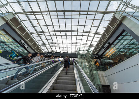 Brussels, Belgium - 03 10 2019: Escalator and glass ceiling of the City 2 shopping mall and Fnac shop Stock Photo