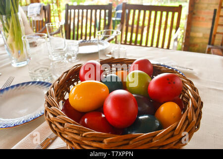 Easter tablewear outdoor under the pergola with colorful eggs in a sunny day Stock Photo