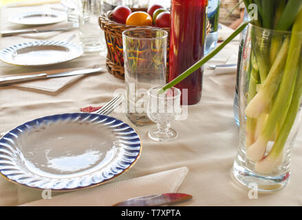 Easter tablewear outdoor under the pergola with colorful eggs in a sunny day Stock Photo