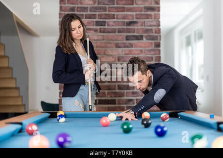 Fashionable couple playing snooker. Stock Photo