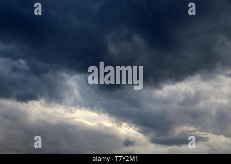 Storm sky covered with dark cumulus clouds before the rain. Dark cloudy sky, overcast day, beautiful dramatic background for stormy weather Stock Photo