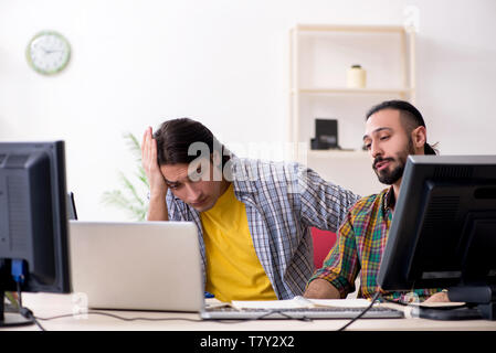 Two it specialists working in the office Stock Photo