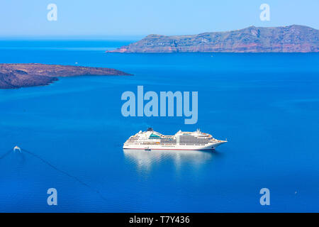 Panoramic sea view from Fira town to caldera, volcano island and cruise ship in Santorini, Thira, Greece Stock Photo