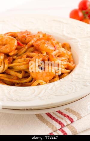 Spicy prawn linguine pasta in a chili and tomato sauce Stock Photo