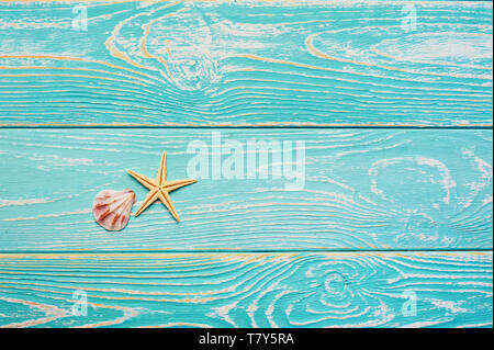 blue wooden background with starfish and shell. Summer beach minimal concept with free space for text. sea vacation backdrop Stock Photo
