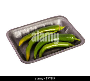 green chilli peppers in a plastic black tray. on a white Stock Photo
