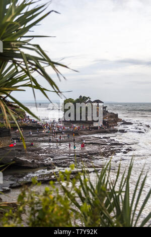 BALI, INDONESIA - JANUARY 26, 2019: Unidentified people by Tanah Lot temple at Bali, Indonesia. It is ancient Hindu pilgrimage temple and one of Bali’ Stock Photo