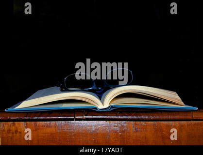 Open book close-up with eye-glasses Stock Photo