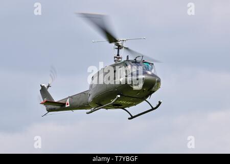 Bell UH-1 Iroquois 'Huey' flying at the season premiere at Shuttleworth on the 5 May 2019 Stock Photo