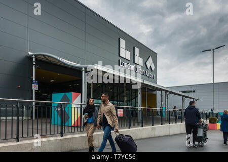 Luton Airport new terminal building logo with South Asian couple hand in hand and smiling Stock Photo