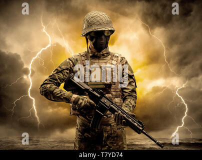 Armed soldier standing in rainy obscure weather  Stock Photo