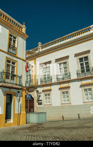 Empty alley with facades of old colorful houses at Elvas. A gracious city on the easternmost frontier of Portugal. Stock Photo