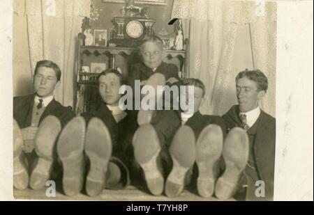 Men in posed humorous photo, ca. 1900 (one of two photos.)  RPPC Stock Photo