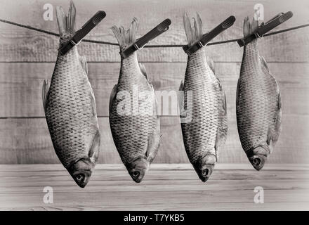Dried roach hanging on a rope on clothespins Stock Photo