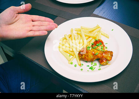 Chicken legs with french fries potatoes Stock Photo