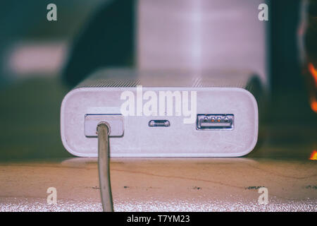 Powerbank for charging gadgets on table Stock Photo