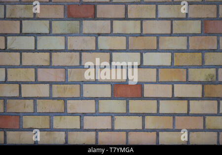 orange red brick wall background with grey grout. Stock Photo