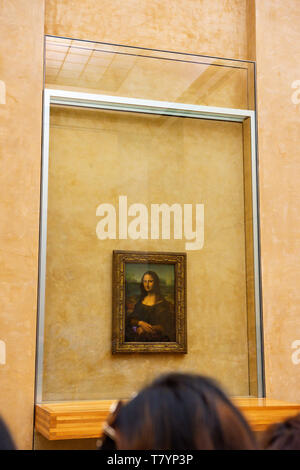 Louvre Museum Visitors Taking Pictures of Leonardo da Vinci's Mona Lisa Painting with their cameras. The painting is one of the world's most famous Stock Photo