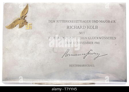 Richard Kolb (1891 - 1945) - Hermann Göring (1893 - 1946). A silver cigarette box with applied Luftwaffe national eagle in gold, engraved 'Dem Ritterkreuzträger und Major d.R. Richard Kolb mit kameradschaftlichen Glückwünschen zum 12. November 1941 Hermann Göring Reichsmarschall' (To Knight's Cross Winner and Reserve Major Richard Kolb with comradely best wishes on 12 November 1941 Hermann Göring Reich Marshal). The box interior lined with wood, the base edge punched with '835', a crescent, crown and jeweller's mark. 15 x 10 cm. Weight 311 g. Kolb had entered the NSDAP in 1, Editorial-Use-Only Stock Photo