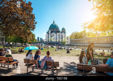 Berlin, Germany - April, 2019: People in public park on a sunny day near Museum Island and Berlin Cathedral Stock Photo