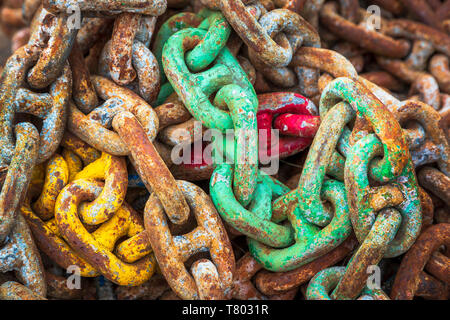 Old rusty industrial heavy duty chains lying at a workplace near a harbour, Ayrshire, Scotland, UK Stock Photo