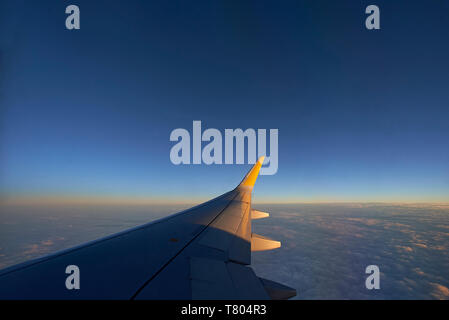 Beautiful shot of the wing of an airplane high in the sky at altitude Stock Photo