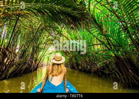Sailing the tributaries of the Mekong River to reach a village to see how they make coconut candy, Vietnam, Indochina, Southeast Asia, Asia Stock Photo