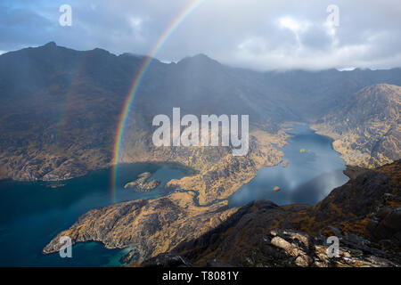 A rainbow above Loch Coruisk and the main Cuillin ridge seen from the top of Sgurr Na Stri on the Isle of Skye, Inner Hebrides, Scotland, UK Stock Photo