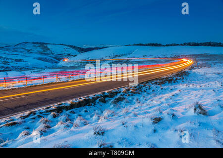 View of trail lights on frozen landscape near Buxton at dusk, High Peak, Derbyshire, England, United Kingdom, Europe Stock Photo