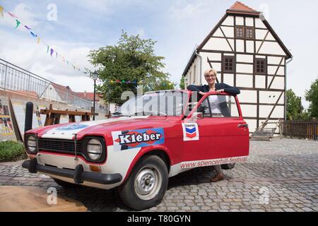 Lommatzsch, Germany. 09th May, 2019. Anita Maaß (FDP), Mayor of Lommatzsch, stands in front of the Terence Hill Museum on a replica of a Ford Escort MK1 Coupe from the film 'Two like pitch and sulphur'. The museum in honour of the actor whose real name is Mario Girotti will be opened on 11 May 2019 in the town of 5000 inhabitants. Credit: Sebastian Kahnert/dpa-Zentralbild/dpa/Alamy Live News Stock Photo