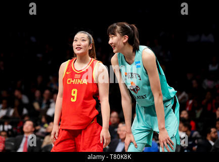 (190510) -- NEW YORK, May 10, 2019 (Xinhua) -- Han Xu (R) of New York Liberty reacts with Li Meng of Chinese Women's National Basketball Team during a friendship game between New York Liberty and Chinese Women's National Basketball Team in New York, the United States, May 9, 2019. New York Liberty won 89-71. (Xinhua/Wang Ying) Stock Photo