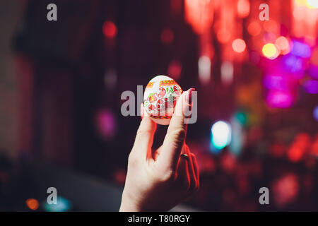hands holding easter eggs, isolated on on the background of the club Stock Photo