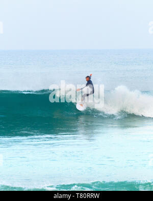 BALEAL, PENICHE, PORTUGAL - DECEMBER 13, 2016: Surfer riding a wave. Peniche is the famous surfing resort in Portugal Stock Photo