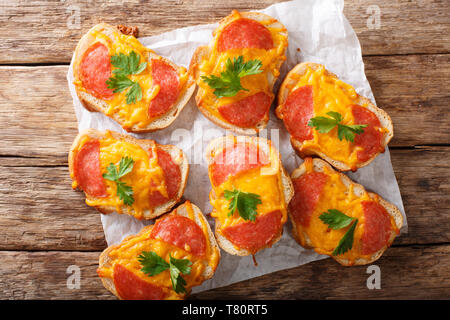 Texas toasts with sausage and melted cheddar cheese close-up on the table. horizontal top view from above Stock Photo