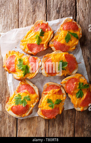 Texas toasts with sausage and melted cheddar cheese close-up on the table. Vertical top view from above Stock Photo