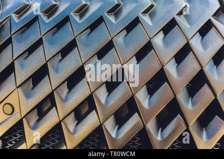 Grid of car with sunflare. Radiator grille. Metal close-up texture background. Chrome grill of big powerful engine macro. Stock Photo