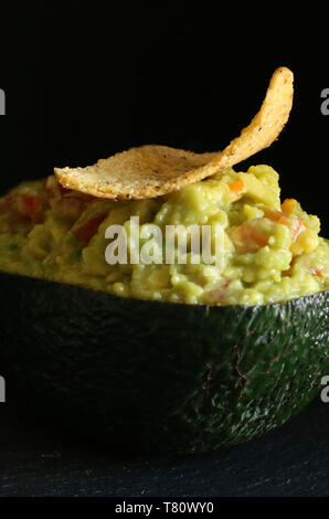 Guacamole with Tortillas on a black background Stock Photo