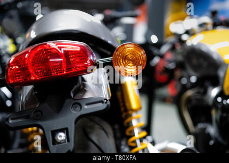 Close up of the rear of a brand new clasic motorcycle, soft focus, abstract background - Image Stock Photo