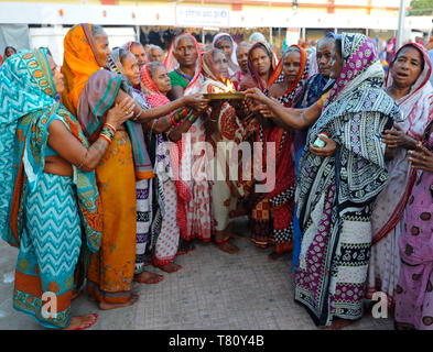 Widows gathered to celebrate Kartika Brata month long festival by fasting together and burning puja lamps, Puri, Odisha, India, Asia Stock Photo