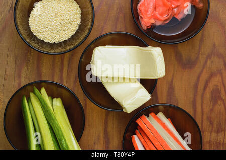 Bright tasty products in plates on the table as ingredients for the preparation of sushi shooting from the top viewpoint 2019 Stock Photo