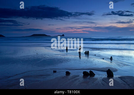 Dusk over the wreck of the Helvetia and Worms Head at Rhossili Bay, Gower, Wales, United Kingdom, Europe Stock Photo