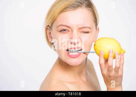 Recharge your body vitamins. Girl drink fresh juice whole lemon fruit. Energy source and vitality. Battery concept. Nutritious drink fill with energy. Lemon with hobnail natural battery. Stock Photo