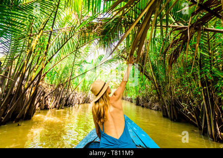 Sailing the tributaries of the Mekong River to get to a village to see how coconut candy is made, Vietnam, Indochina, Southeast Asia, Asia Stock Photo