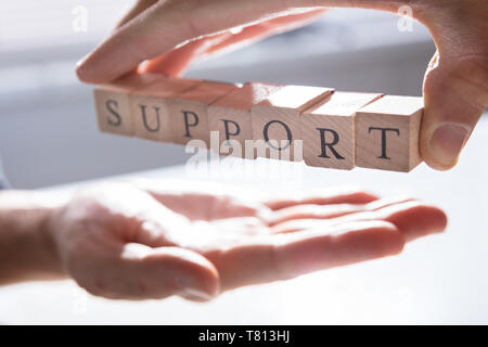 Close-up Of Person's Hand Giving Support To Other Person Stock Photo