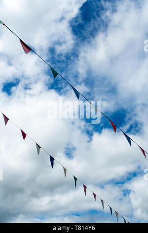 The colorful triangle flags hanging on a rope Stock Photo - Alamy