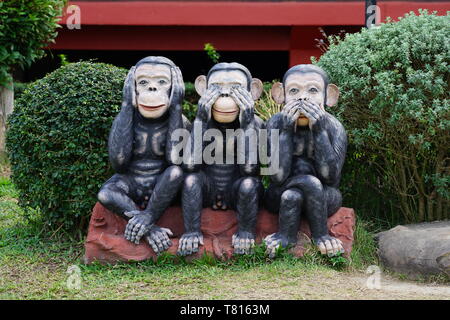 three black monkeys statue siting on the rock in the row; close eyes, close mouth, close ear., Thailand Stock Photo